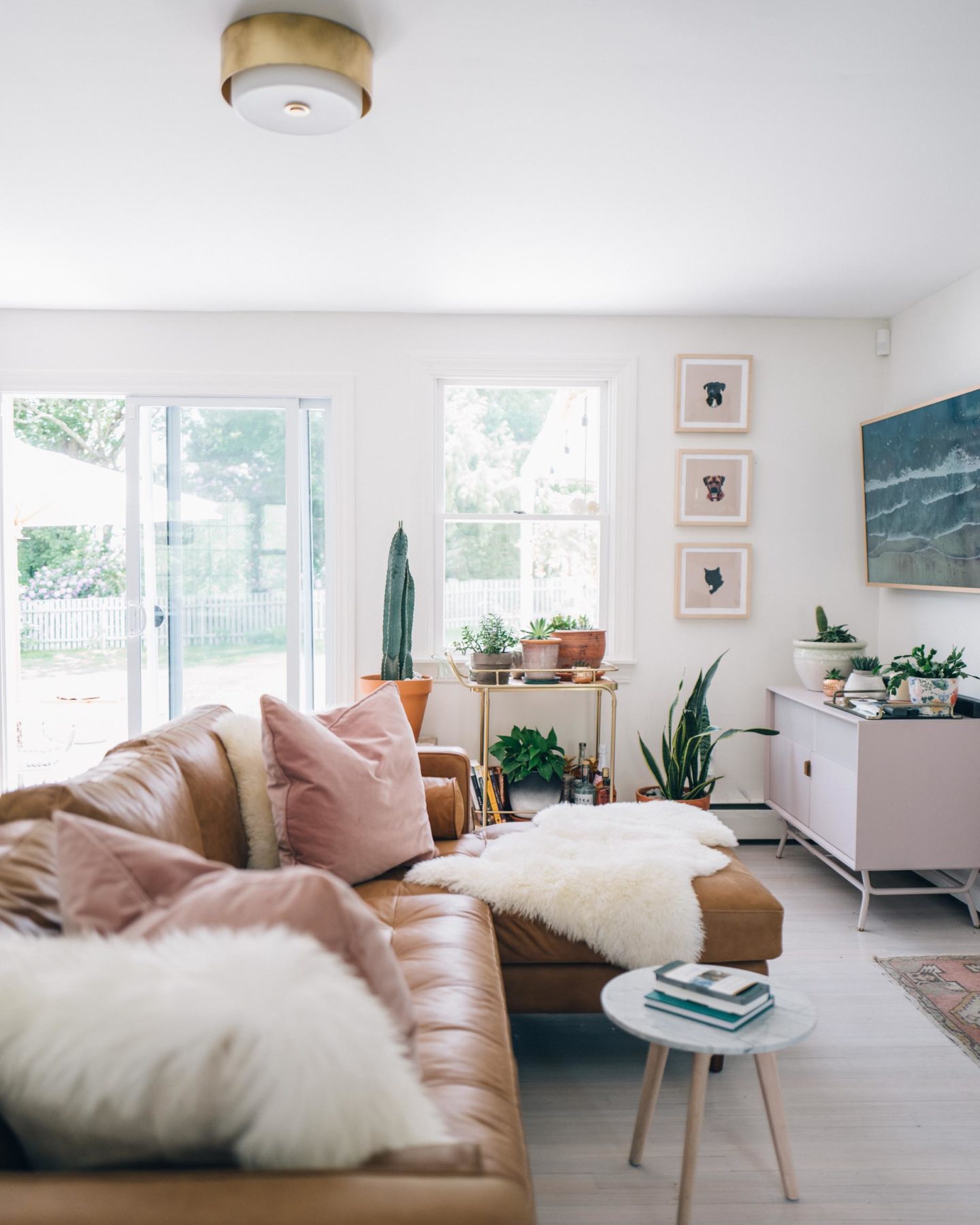 Jess Ann Kirby styles the Article Sven Sectional with peach pillows and faux fur throws.