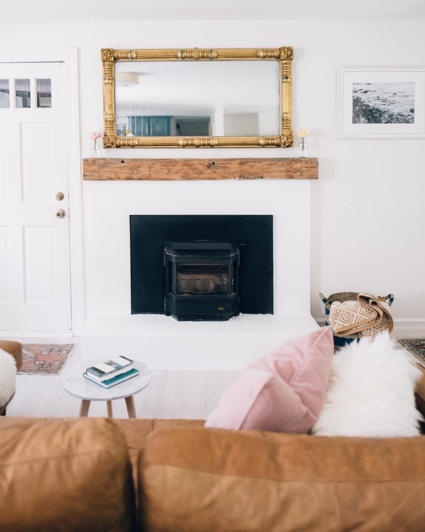 Jess Ann Kirby updates her fireplace with a rustic wood mantle and white washed brick.