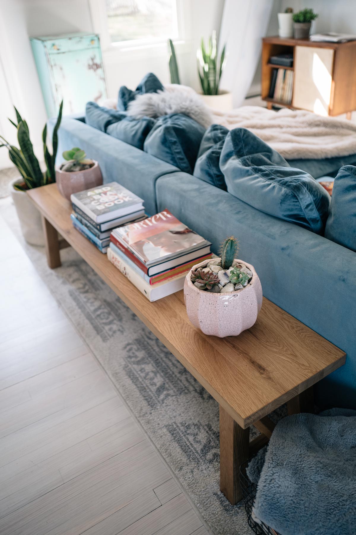 Jess Ann Kirby styles her living room with stylish pieces like a terracotta pot from Anthropologie