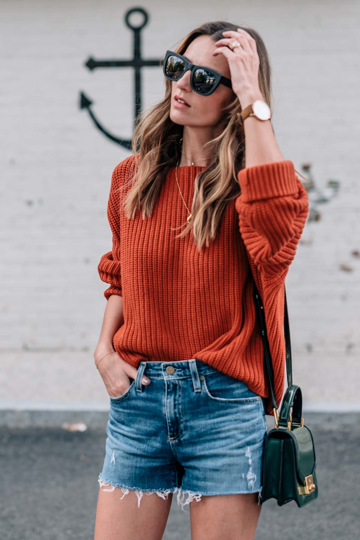 Jess Ann Kirby's fall style in a chunky knit sweater in pantone autumn maple and jean shorts