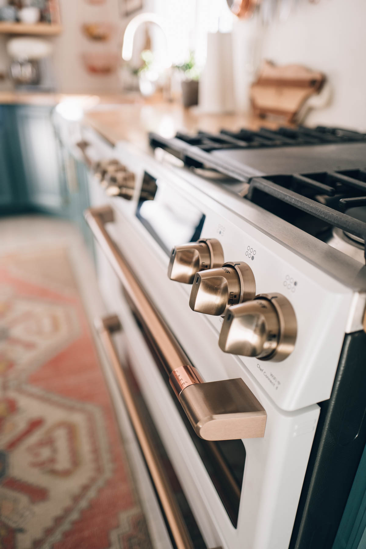 Brushed Bronze Hardware on the Cafe Appliance Matte White Dual-Fuel Double Oven with Convection Range