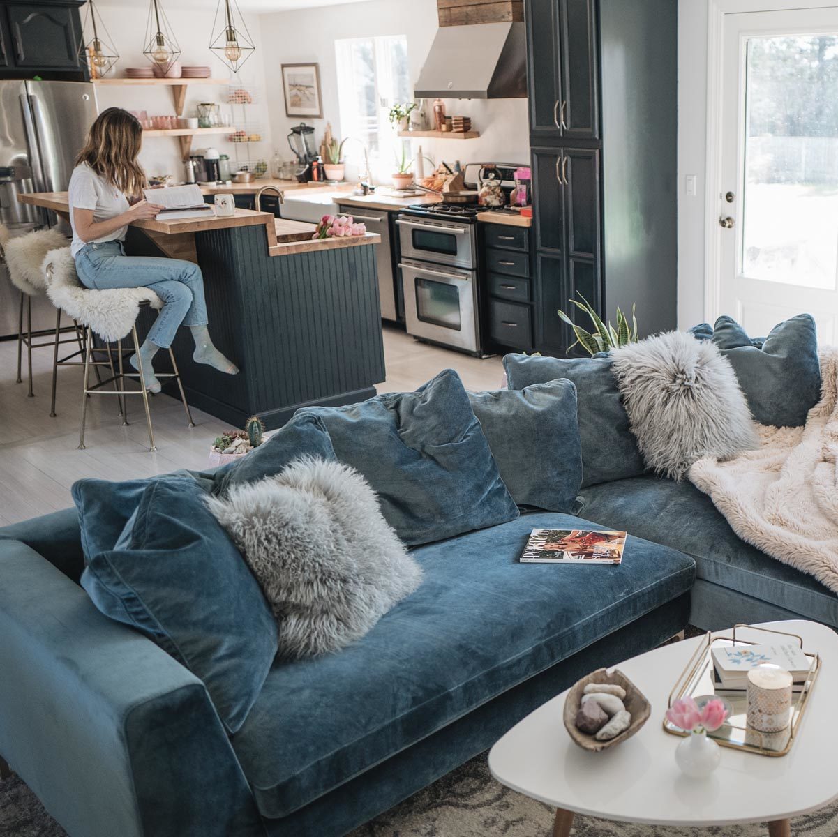 Jess Ann Kirby reveals her living room renovation featuring a velvet sectional sofa