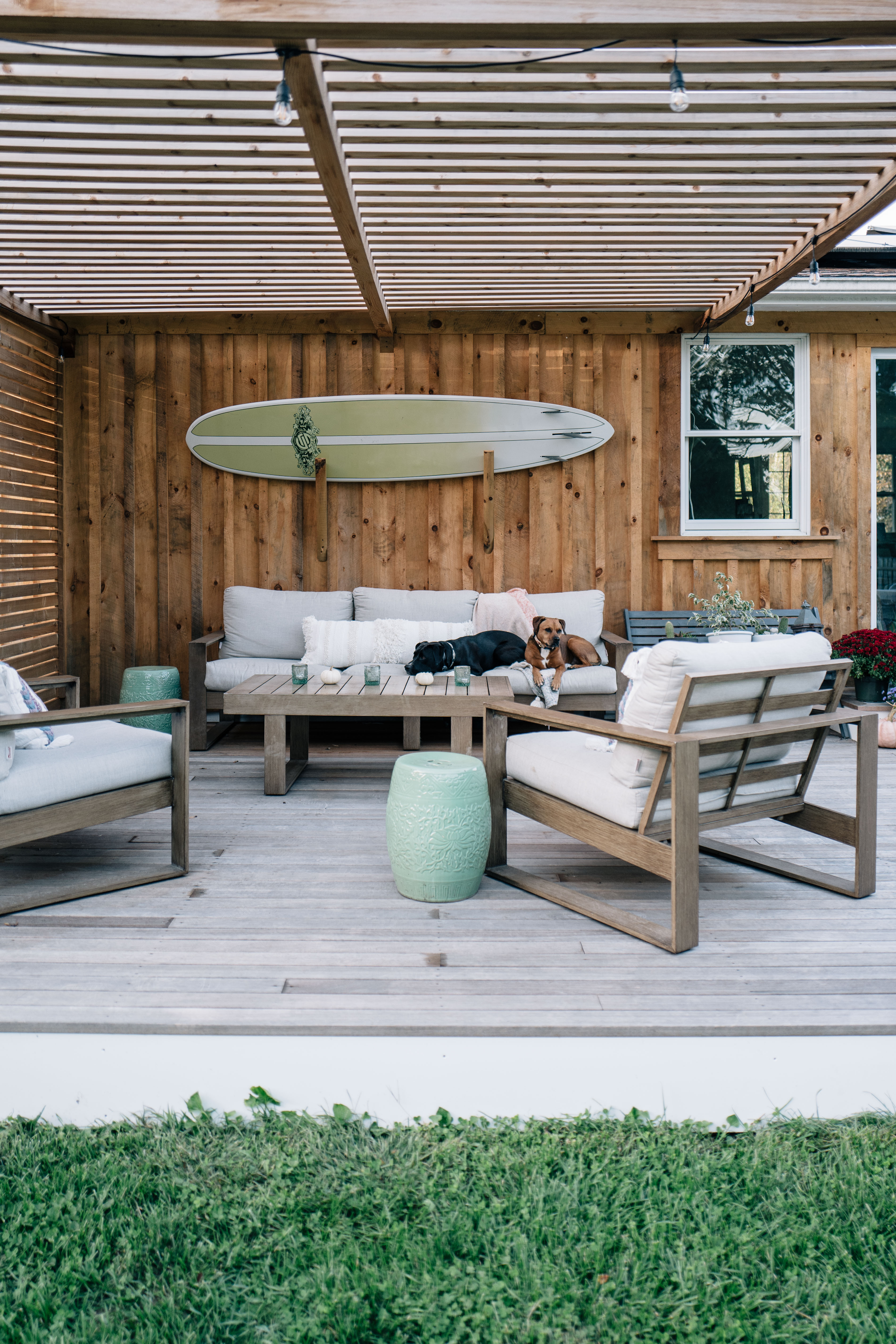 Jess Ann Kirby reveals her outdoor space renovation with a pine board and batten siding cedar pergola