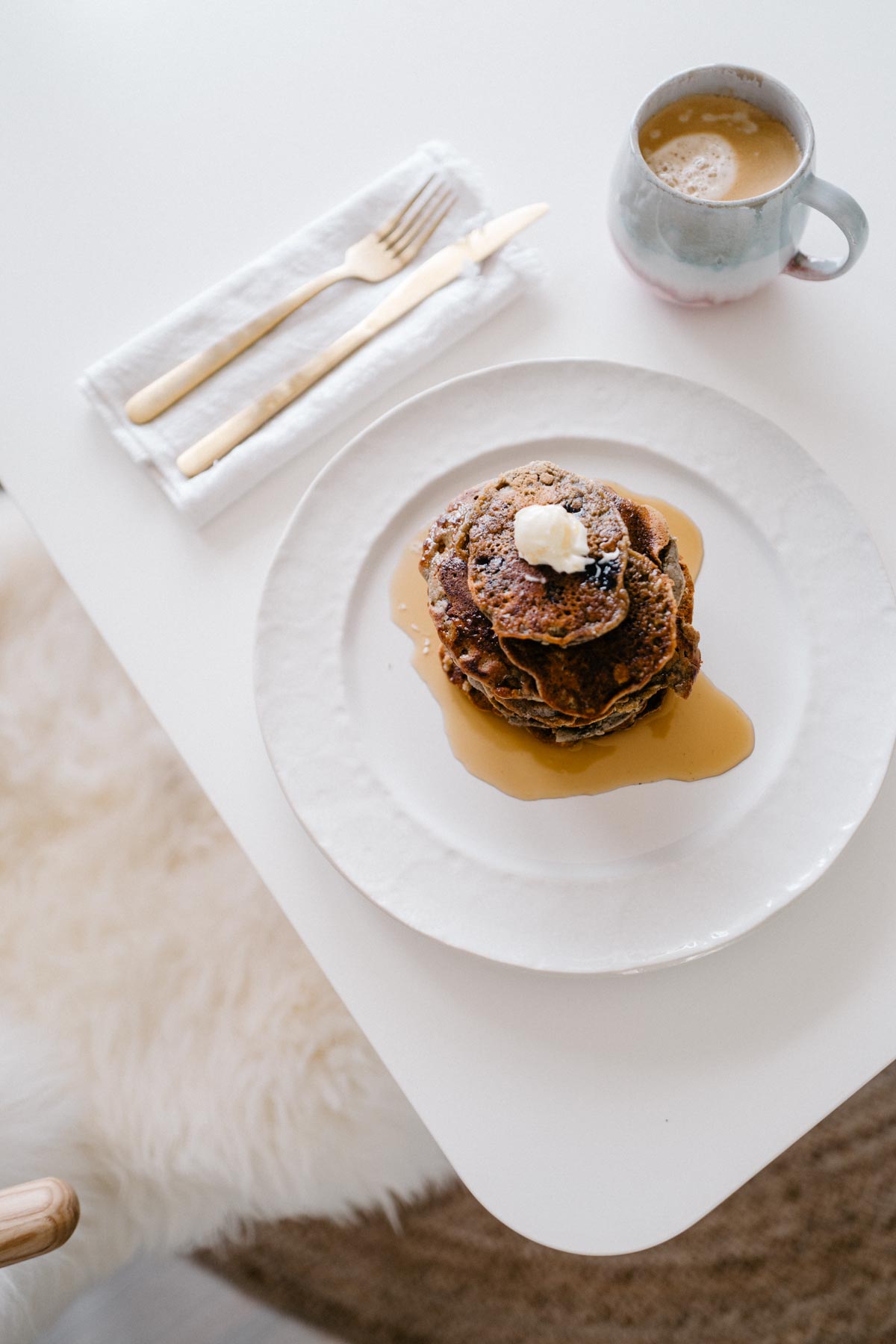 The perfect morning includes a big stack of vegan pancakes and a hot cup of coffee with almond milk.