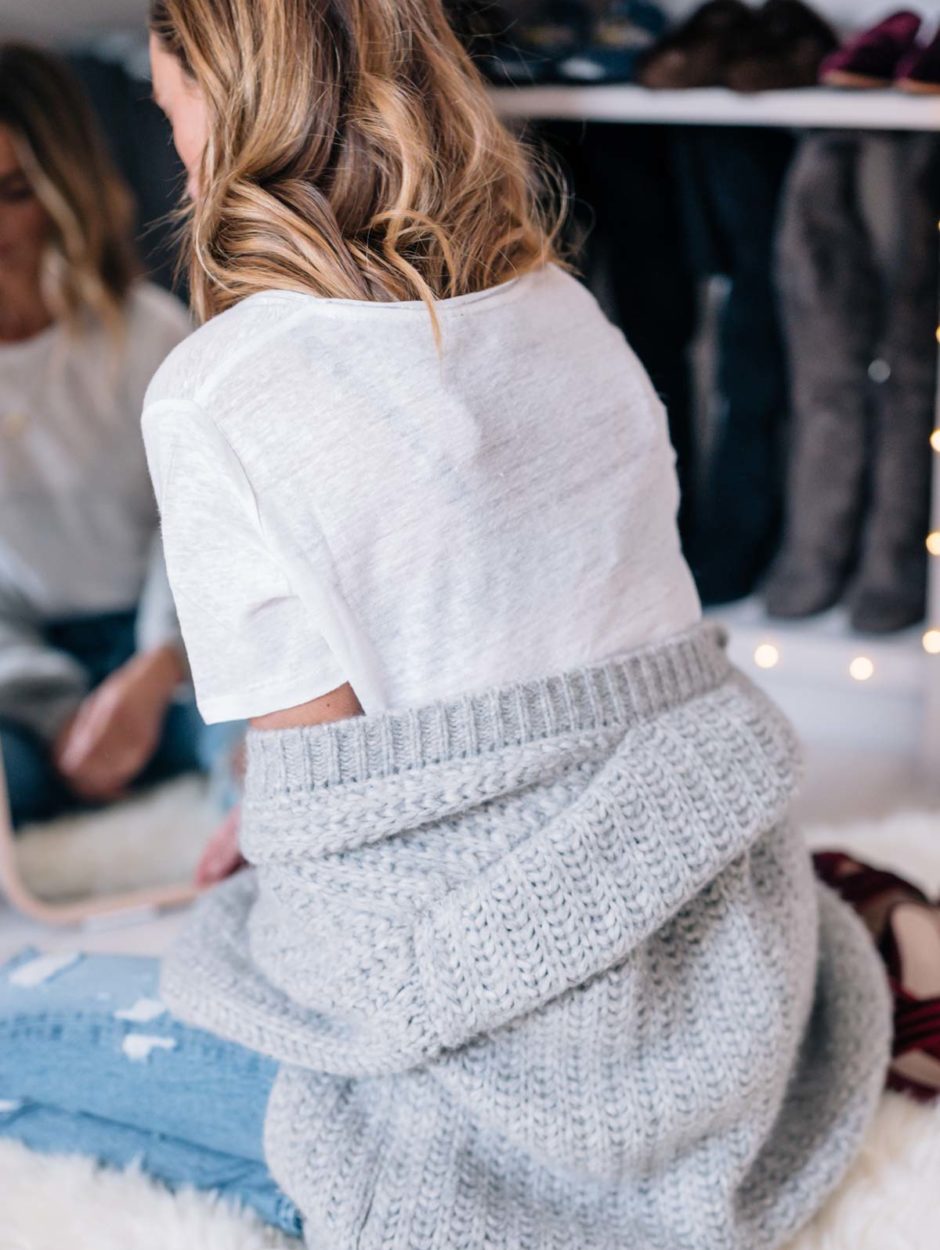 Jess Ann Kirby gets comfortable at home with a chunky knit sweater and white tee