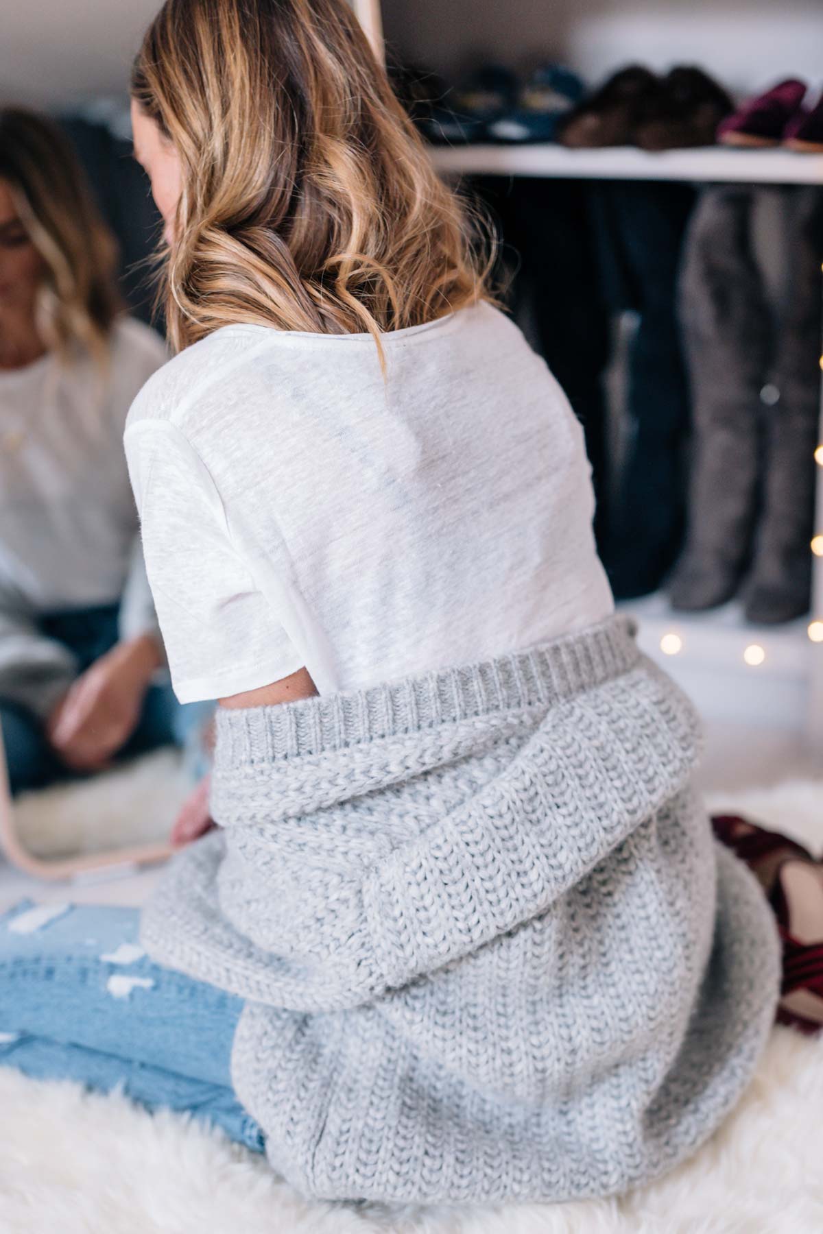 Jess Ann Kirby gets comfortable at home with a chunky knit sweater and white tee