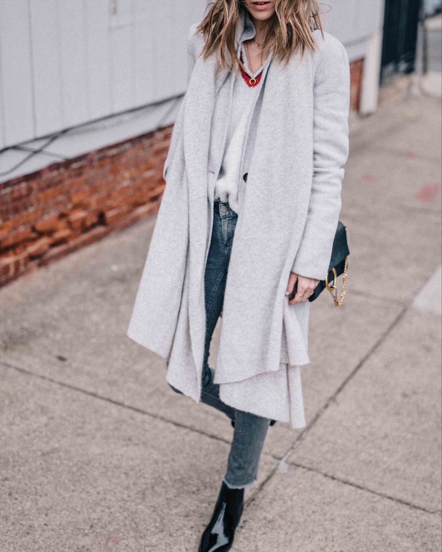 Jess Ann Kirby styles the White and Warren Travel Wrap with Paige jeans and booties