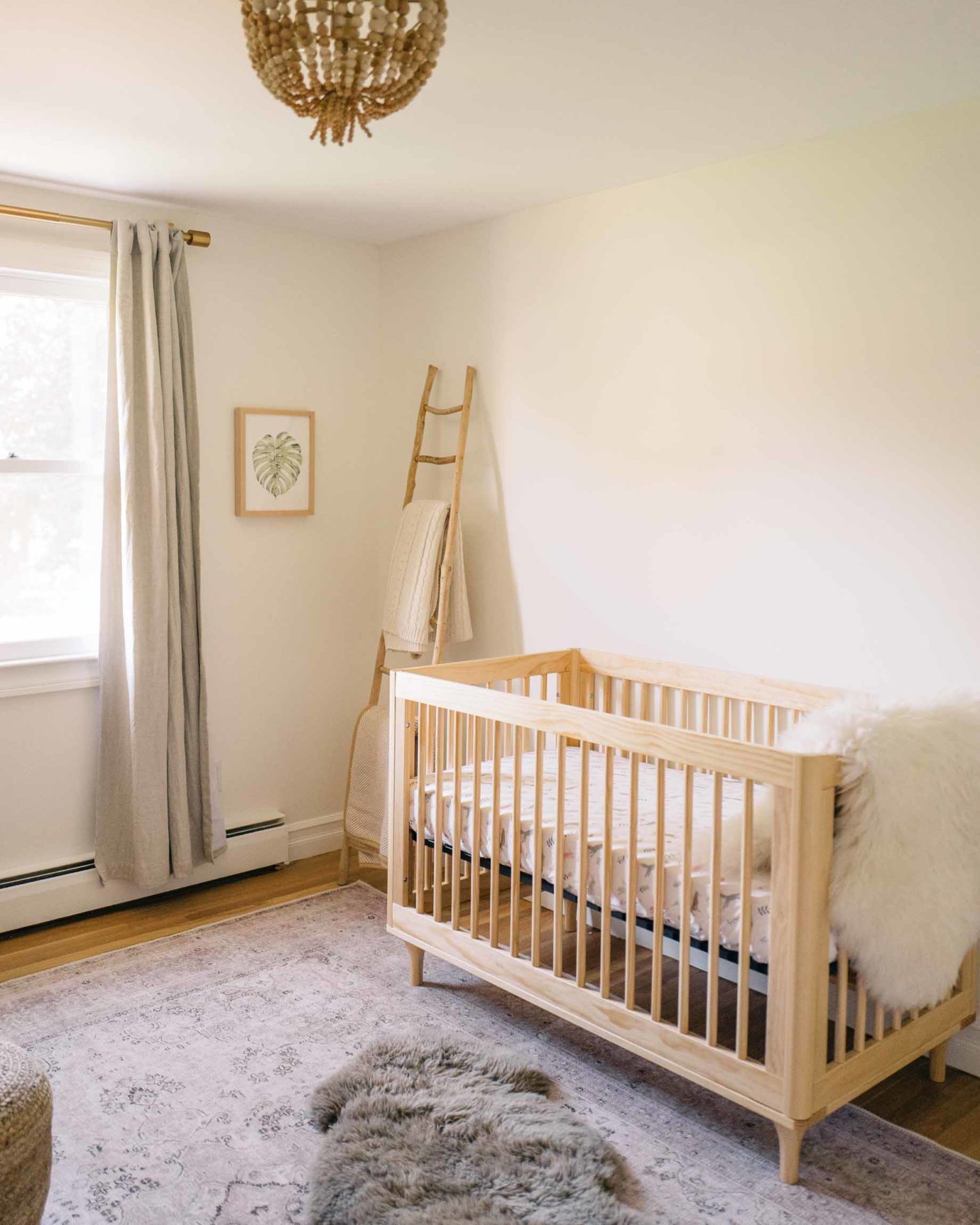 Jess Ann Kirby's gender neutral crib is a light wood with cozy textures perfect for baby.