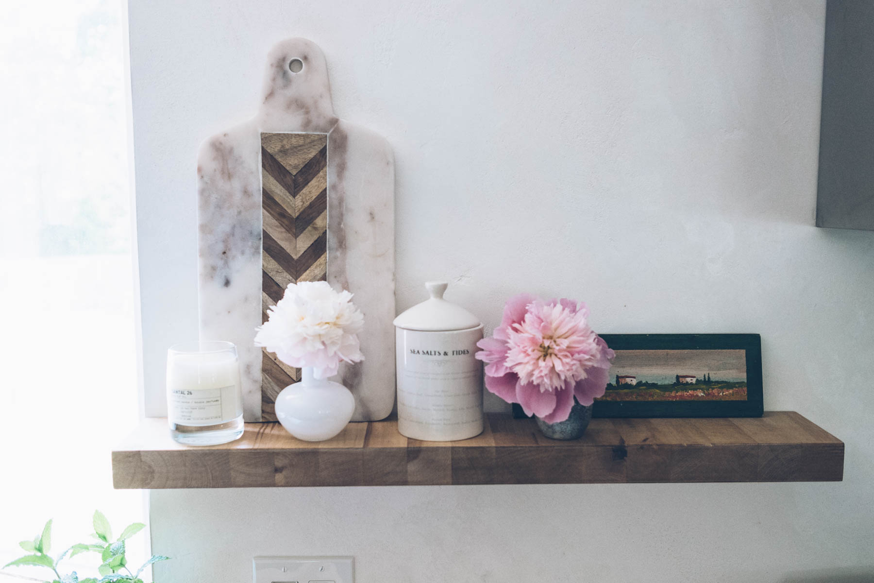 Jess Kirby's kitchen with open shelving and plaster walls