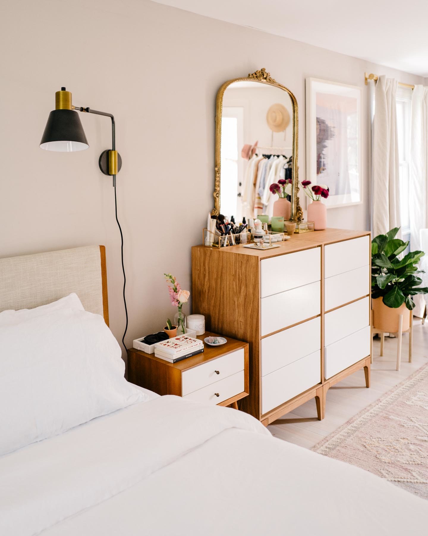 Jess Ann Kirby decorates her master bedroom with bright furniture and white bedding for a open, relaxing space.