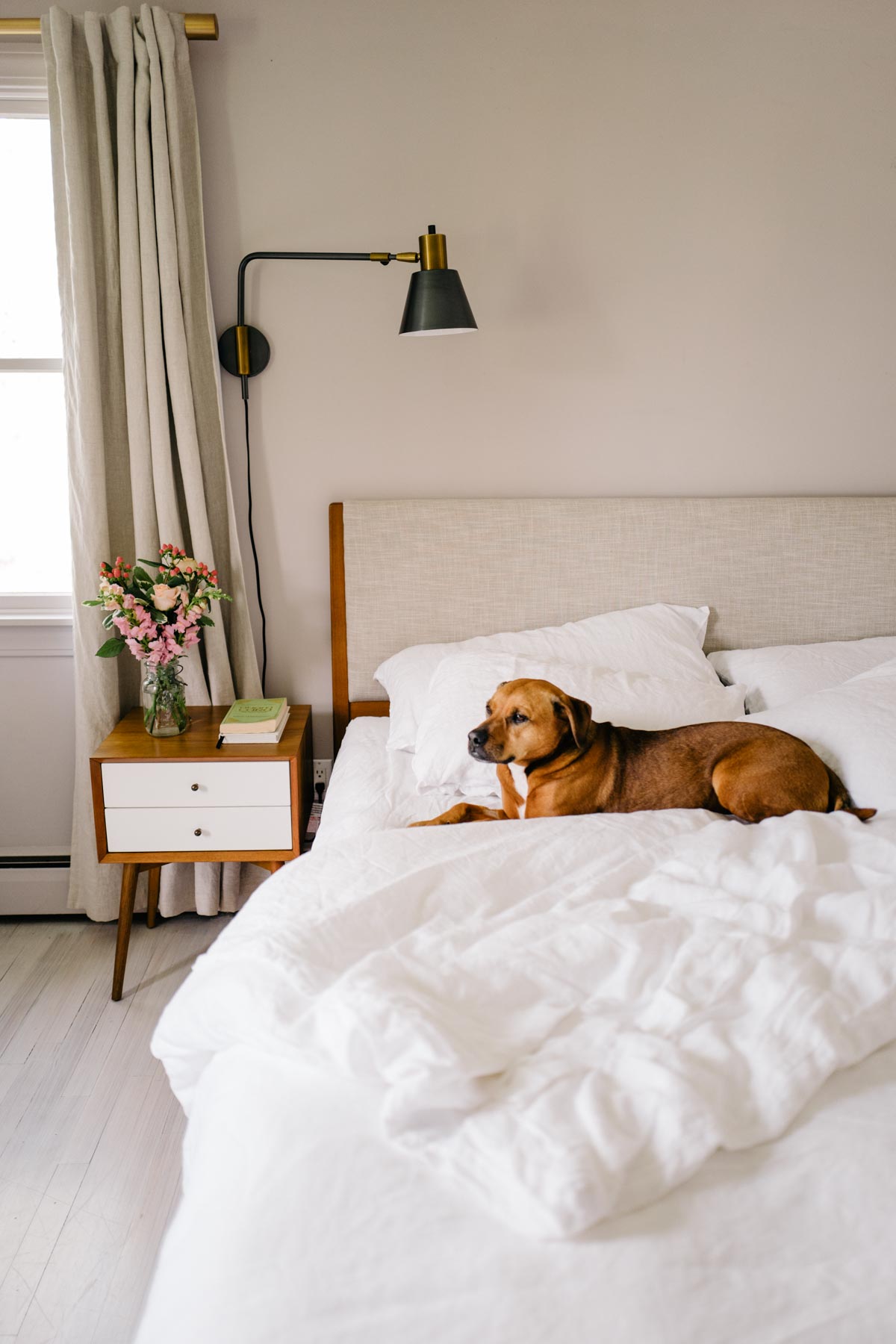 Jess Ann Kirby refreshes her master bedroom with hanging sconces, a new headboard and fresh bedding.