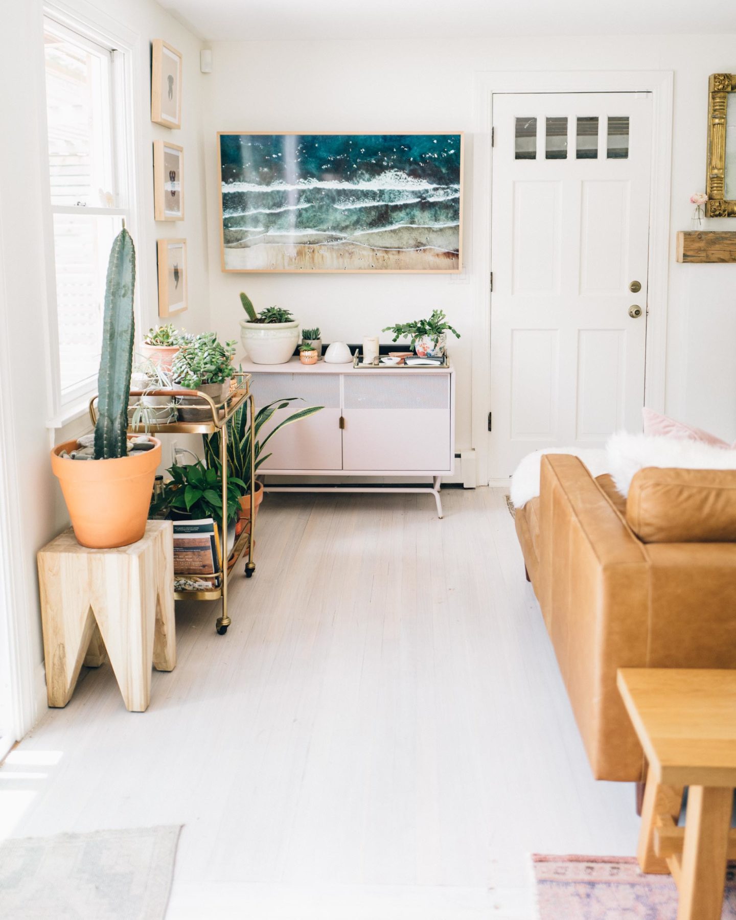 Jess Ann Kirby updated her living space with a pink media stand and brown leather sofa.