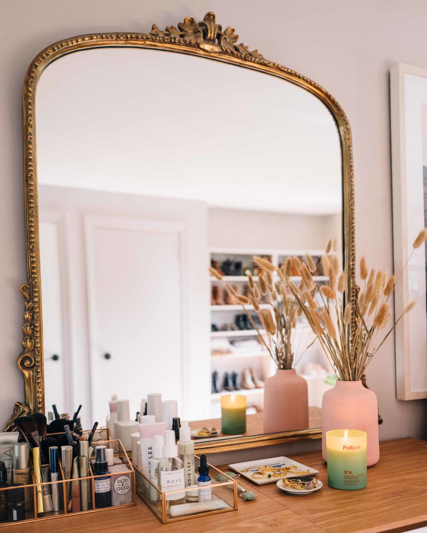 Jess Ann Kirby's bedroom vanity includes her favorite clean beauty products, jewelry trays and non-toxic candles from Follain.